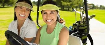 two women golfers in a cart